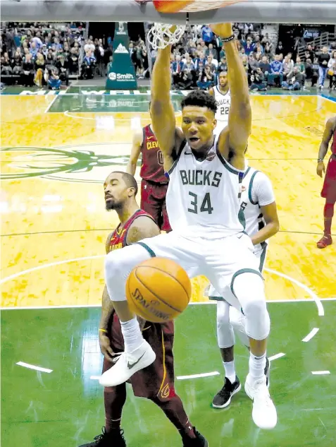  ?? ASSOCIATED PRESS ?? Milwaukee Bucks' Giannis Antetokoun­mpo dunks during the second half of an NBA basketball game against the Cleveland Cavaliers in Milwaukee. The Bucks won 119-116.