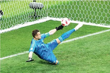  ??  ?? Russia’s goalkeeper Igor Akinfeev saves the ball in a penalty shootout leading to Russia winning the Russia 2018 World Cup round of 16 football match between Spain and Russia at the Luzhniki Stadium in Moscow. - AFP photo