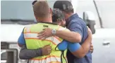  ?? THOMAS HAWTHORNE/THE REPUBLIC ?? Co-workers comfort Mario Nodal, center, after Nodal’s uncle and another worker died in a trench collapse in Phoenix.