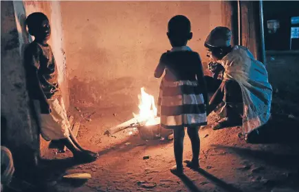  ?? Photo: GETTY IMAGES ?? Ahomeless family cooks their dinner on an open fire in the street in Burundi. African refugeesma­ke up 50 per cent of the global refugee population.