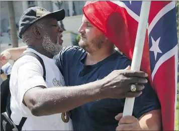  ?? — GETTY IMAGES ?? Ernest Branch, left, hugs a man carrying a Confederat­e flag Tuesday, saying he respects the fact the man likes the flag. Branch, however, also said he is against the flag flying on the statehouse grounds in Columbia, S.C.