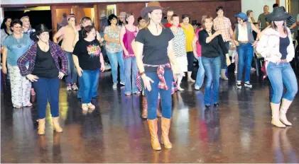  ??  ?? Line dancers from Mystic Moon show guests how it’s done Muzi Zincume and Mari Scott