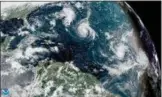  ?? NOAA VIA AP ?? This enhanced satellite image made available by NOAA shows Tropical Storm Florence, center, in the Atlantic Ocean on Saturday at 2:45 p.m. EDT.