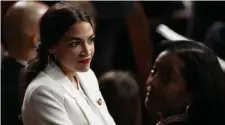  ?? AP ?? CALL TO ACTION: Reps. Alexandria Ocasio-Cortez (D-N.Y.) and Jahana Hayes (D-Conn.), from left, stand together on the House floor at the U.S. Capitol on the first day of the 116th Congress.