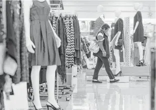  ?? Michael Ciaglo / Houston Chronicle ?? Francy Lennis walks past a group of mannequins at Palais Royal at the Westchase Shopping Center earlier this month. Stage Stores, owner of Palais Royal and other retail stores, announced a drop in holiday sales of 2.5 percent this season.