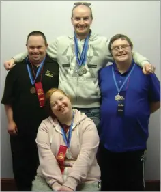  ??  ?? KARE Tinahely service-users Michael Connolly, Peter Kelly, Andrew Gahan and (front) Fiona Healy proudly show of the medals they brought home from Drogheda.