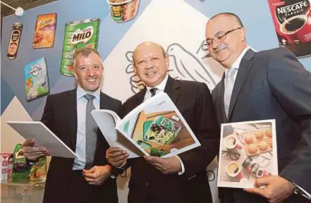  ?? PIC BY AMIRUDIN SAHIB ?? (From left) Nestle Malaysia Bhd chief executive officer Juan Aranols, chairman Tan Sri Syed Anwar Jamalullai­l and chief financial officer Craig Connolly at the company’s annual general meeting in Kuala Lumpur yesterday.