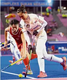  ??  ?? Close attention: Hong Kong’s Weeraya Ho closing down Malaysia’s Juliani Mohamad Din during the women’s World Hockey League Second Round match at the Tun Razak Stadium yesterday. Malaysia won 9- 0.
By S. RAMAGURU