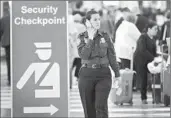  ?? Scott Olson Getty Images ?? A SIGN at O’Hare Internatio­nal Airport directs travelers to a checkpoint staffed by TSA agents.