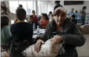  ?? VASILY KRESTYANIN­OV — THE ASSOCIATED PRESS ?? Ethnic Armenians from Nagorno-Karabakh gather as they wait to receive humanitari­an aid at a temporary camp in Armenia's Goris in Syunik region, Armenia, on Tuesday.