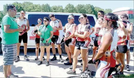  ??  ?? Riders on the Remember the Removal bike ride stop and talk after arriving at the Pea Ridge National Military Park June 20.