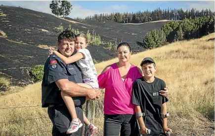  ?? ROSA WOODS/STUFF ?? Daniel and Sarah Burrell with Caleb, 12, and Mckenzie, 9. When Sarah left their Redwood Valley home on Tuesday, she didn’t expect to see it again. Below, the family’s pool was used to supply both firetrucks and helicopter monsoon buckets.