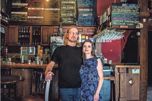  ?? ELI IMADALI/THE REPUBLIC ?? Eric and Lauren Dahl, owners of The Lost Leaf, stand for a portrait in their bar in Phoenix April 17, 2020.