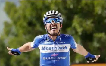  ?? CHRISTOPHE ENA - THE ASSOCIATED PRESS ?? Julian Alaphilipp­e celebrates as he crosses the finish line to win the third stage of the Tour de France on July 8 in Epernay, France.