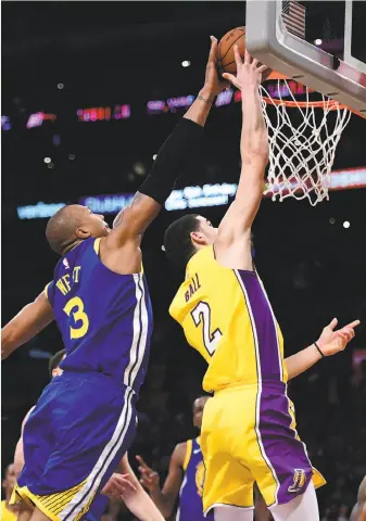  ?? Harry How / Getty Images ?? Top: Golden State’s David West blocks Lonzo Ball’s attempt at a game-tying layup in the final seconds of overtime.