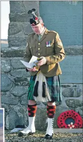  ?? 50_c46RDglenb­arr03 ?? Colour Sergeant Robbie Semple, above, chairman of Glenbarr War Memorial, presented copies of the memorial book to the youngsters who took part in the service.