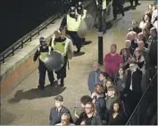  ?? Carl Court Getty Images ?? PEOPLE are led to safety after the June 3 attack in London. Preventing such strikes is a challenge.