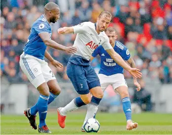  ?? — AFP ?? Tottenham Hotspur striker Harry Kane (centre) vies for the ball with Cardiff City’s Sol Bamba (left) during their English Premier League match at the Wembley Stadium in London on Saturday. Tottenham won 1-0.