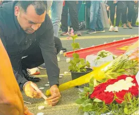  ?? Photo / George Block ?? Candles were lit at the vigil for the slain dairy worker.