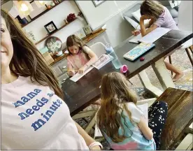  ?? AMBER CESSAC VIA AP ?? Amber Cessac taking a selfie as her daughters do their homework at their home in Georgetown, Texas, on Sept. 9.