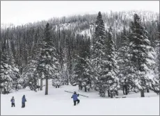  ?? PHOTO CALIFORNIA DEPARTMENT OF WATER RESOURCES ?? The state Department of Water Resources survey team trudges through snow to conduct the first 2022 survey of the snowpack at Phillips Station in the Sierra Nevada.