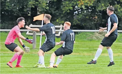  ?? ?? Matchwinne­r Stoneyburn players rush to celebrate with keeper Matty Craig after his penalty save