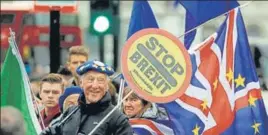  ?? AP ?? THE CIRCUS CONTINUES: Brexit protesters wave flags outside parliament in London on Tuesday.