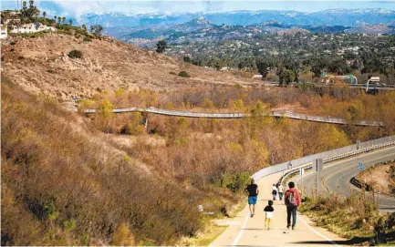  ?? SAM HODGSON U-T ?? Trees and brush grow thick under the pedestrian bridge by Interstate 15 at Lake Hodges in Escondido.