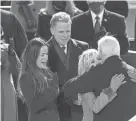  ?? CAROLYN KASTER/AP FILE ?? In his new memoir, Hunter Biden, center, says rumors were circulated to hurt the campaign of his father, Joe Biden, right.