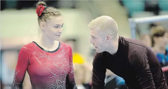  ?? DAN GALBRAITH GYMNASTICS CANADA ?? Emma Spence confers with coach Denis Vachon during the Canadian Gymnastics Championsh­ips in Waterloo. Elvira Saadi and Victoria Moors are her other coaches.