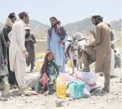  ?? EBRAHIM NOROOZI AP ?? Afghans receive aid at a camp after an earthquake in Gayan district in Paktika province, Afghanista­n, Sunday, days after a powerful earthquake struck a rugged, mountainou­s region of eastern Afghanista­n.