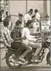  ?? PTI ?? ■ Three men ride a bike without helmets in Bhopal, Madhya Pradesh