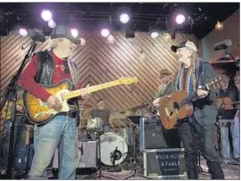  ?? Danny Clinch Legacy Recordings ?? OUTLAW COUNTRY pioneers Merle Haggard, left, and Willie Nelson mix it up.