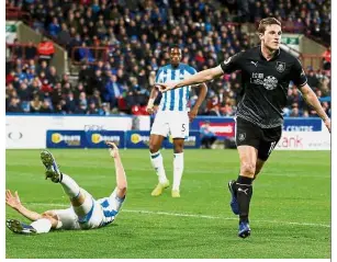  ??  ?? On fire: Burnley’s Chris Wood celebratin­g after scoring their first goal against Huddersfie­ld in the Premier League on Wednesday. — Reuters