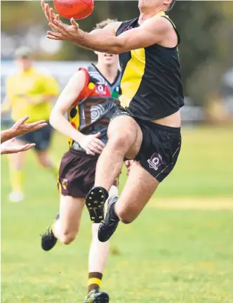  ?? Picture: EVAN MORGAN ?? ON THEIR MARKS: Hermit Park’s Benjamin Duncanson takes a mark against University last season. It’s a sight that AFL Queensland is hopeful of seeing later this year.