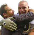  ?? PAT LITTLE /AP ?? When Toledo coach Gary Pinkel, left, seen hugging offensive lineman Michael Schaefer after the Rockets defeated Penn State 24-6 on Sept. 2, 2000, in State College, Pa, accepted the top football job at Missouri in 2001, he appointed Matt Eberflus as the Tigers defensive coordinato­r.