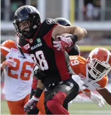  ?? JUSTIN TANG/THE CANADIAN PRESS ?? Redblacks receiver Brad Sinopoloi tries to evade a pair of B.C. Lions defenders on Saturday in Ottawa. Sinopoli had four catches for 61 yards.