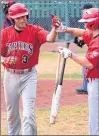  ?? SALTWIRE NETWORK PHOTO/ GARY KEAN/THE WESTERN STAR ?? Trevor Clarke (left) is congratula­ted by St. John’s Capitals teammate Andrew Paul after smwacking a solo home run against the Corner Brook Barons in Game 1 of the provincial senior A baseball final at Jubilee Field in Corner Brook on Saturday. The...