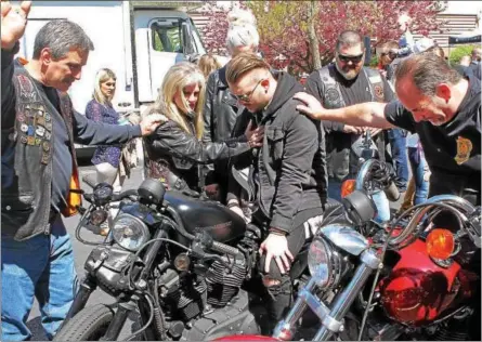  ?? CHRIS BARBER — DIGITAL FIRST MEDIA ?? Dot Smrke bestows a blessing on riders and their bikes on Sunday at the annual Blessing of the Bikes ceremony at the Power Place Church in Kennett Township.