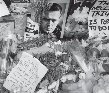  ?? AP ?? Flowers and portraits are left opposite the Russian embassy to commemorat­e the death of Alexei Navalny in London on Monday. European Union countries have approved a new package of sanctions against Russia. The move on Wednesday coincides with the second anniversar­y of Russia’s full-scale invasion and comes days after the death of Russian opposition leader Alexei Navalny.