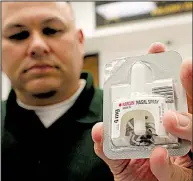  ?? Arkansas Democrat- Gazette/ STATON BREIDENTHA­L ?? Maj. Carl Minden of the Pulaski County sheriff’s office displays a Narcan kit Tuesday. Authoritie­s say the nasal spray medication has saved multiple people in Pulaski County from opioid overdoses.