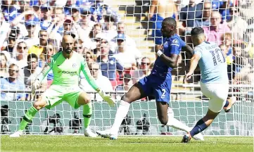  ?? — AFP photo ?? Manchester City’s Argentinia­n striker Sergio Aguero (right) shoots to score the opening goal of the English FA Community Shield football match between Chelsea and Manchester City at Wembley Stadium in north London.