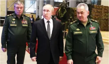  ?? MIKHAIL METZEL, SPUTNIK, KREMLIN POOL PHOTO VIA AP ?? Russian President Vladimir Putin, center, escorted by Russian Defense Minister Sergei Shoigu, right, and General Staff Valery Gerasimov walk after attending an extended 2021 meeting of the Russian Defense Ministry Board at the National Defense Control Center in Moscow, Russia.