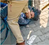  ?? — PTI ?? Police pin down a farmer, who allegedly attacked Police SHO (Alipur) Pradeep Paliwal, during clashes between people claiming to be local villagers and farmers at the Singhu border in New Delhi on Friday.