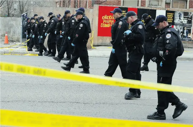  ?? DAVE ABEL / POSTMEDIA NEWS ?? Toronto police continue their investigat­ion Tuesday along Yonge St., a day after a van struck and killed 10 pedestrian­s, injuring 14 others.