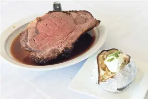  ?? CHRIS KOHLEY / MILWAUKEE JOURNAL SENTINEL ?? Roasted prime rib is the specialty at Michael's House of Prime in Pewaukee. A 20 ounce cut is seen with a baked potato.