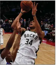  ?? AP/CARLOS OSORIO ?? Milwaukee forward Giannis Antetokoun­mpo shoots as Detroit guard Langston Galloway defends during Game 4 of the teams’ firstround playoff series Monday in Detroit. Antetokoun­mpo scored 41 points as the Bucks won 127-104 to sweep the series.