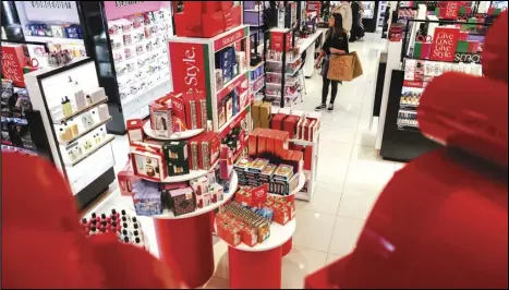  ?? ASSOCIATED PRESS ?? Customers shop in a nearly-empty Macy’s early on Black Friday, in New York.