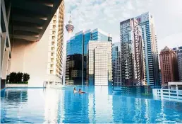  ??  ?? go for a dip in the infinity pool with a view of the city skyscraper­s. — ramada Suites KLCC