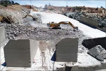  ?? Department of Water Resources ?? Kiewit Infrastruc­ture continues concrete demolition work on Friday on the lower chute of the Lake Oroville flood control spillway, as seen by a drone.